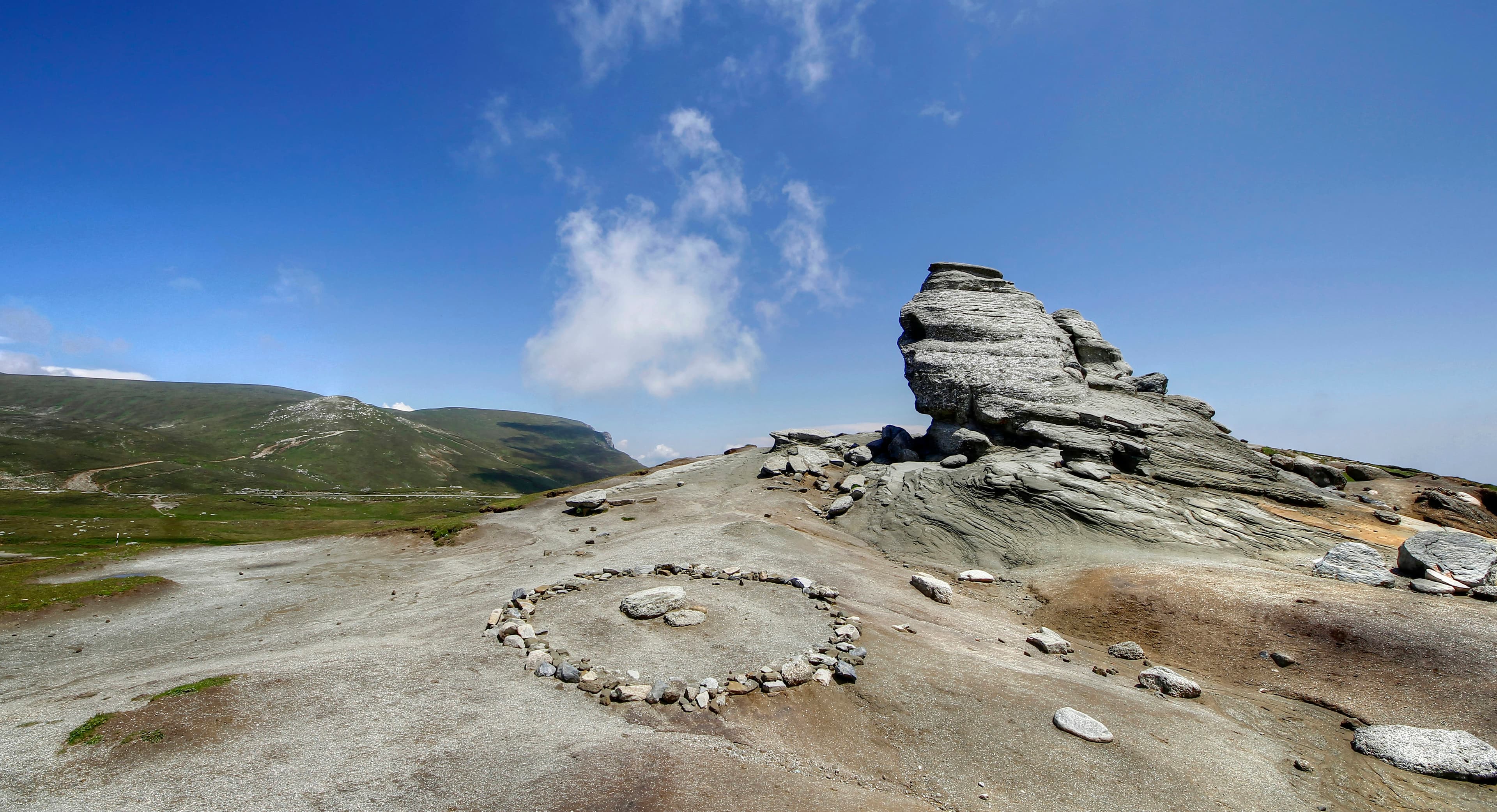 A circle of smooth pebbles resting on a larger stone