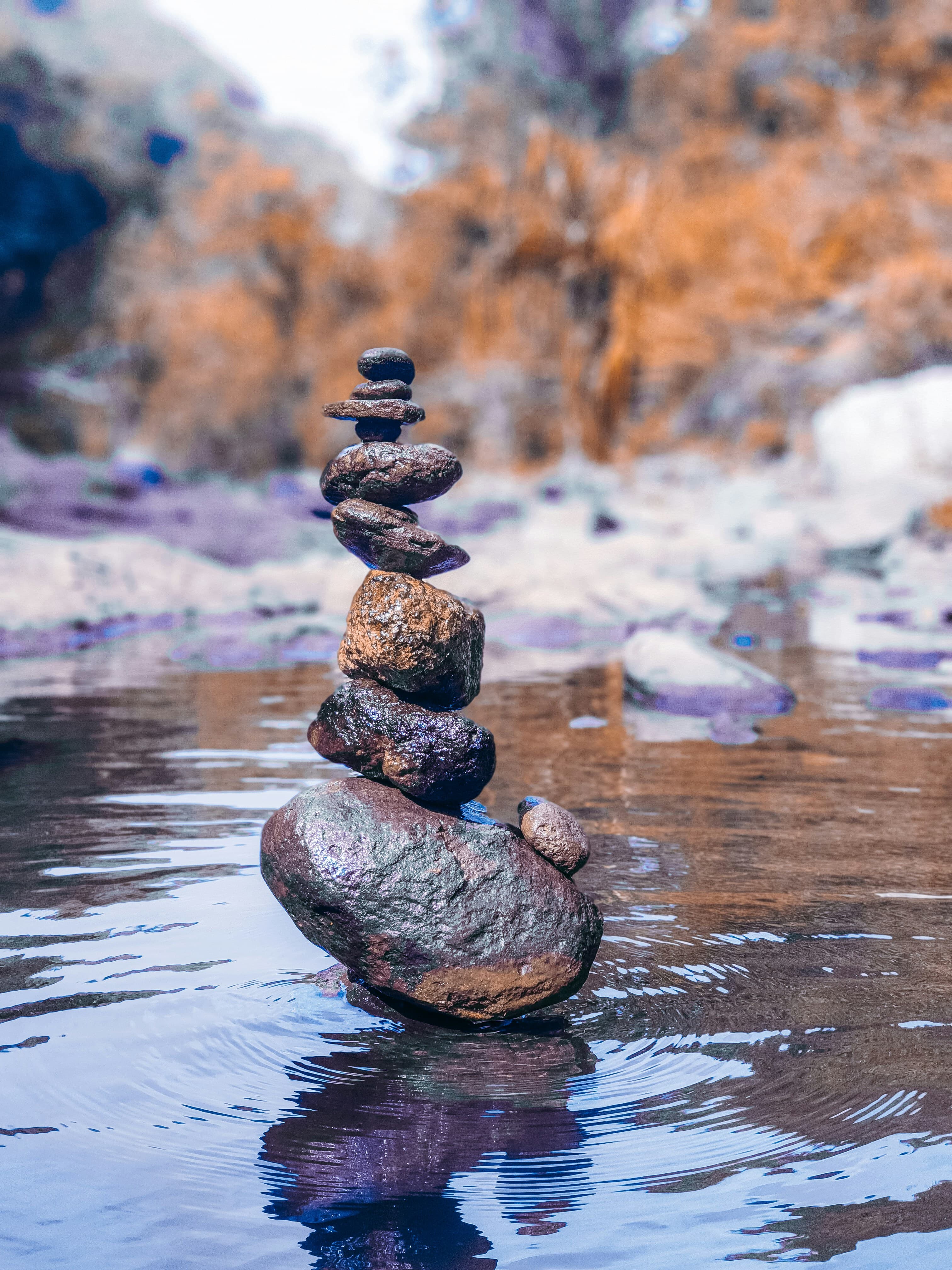 Balanced stones resting on a body of still water